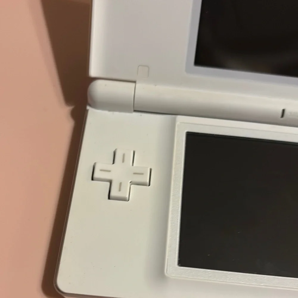 White Handheld Gaming Console with Pink Ribbon